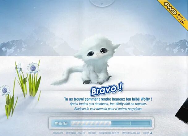 Interface interactive Wofty affichant une créature blanche fantastique dans un décor enneigé, avec message de réussite et barre de progression